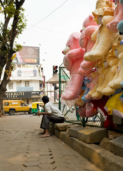 An Indian street seller selling giant teddy bears in Bangalore